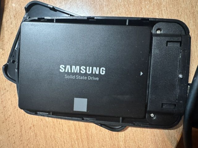 SATA to USB enclosure opened, showing a Samsung SSD installed inside
